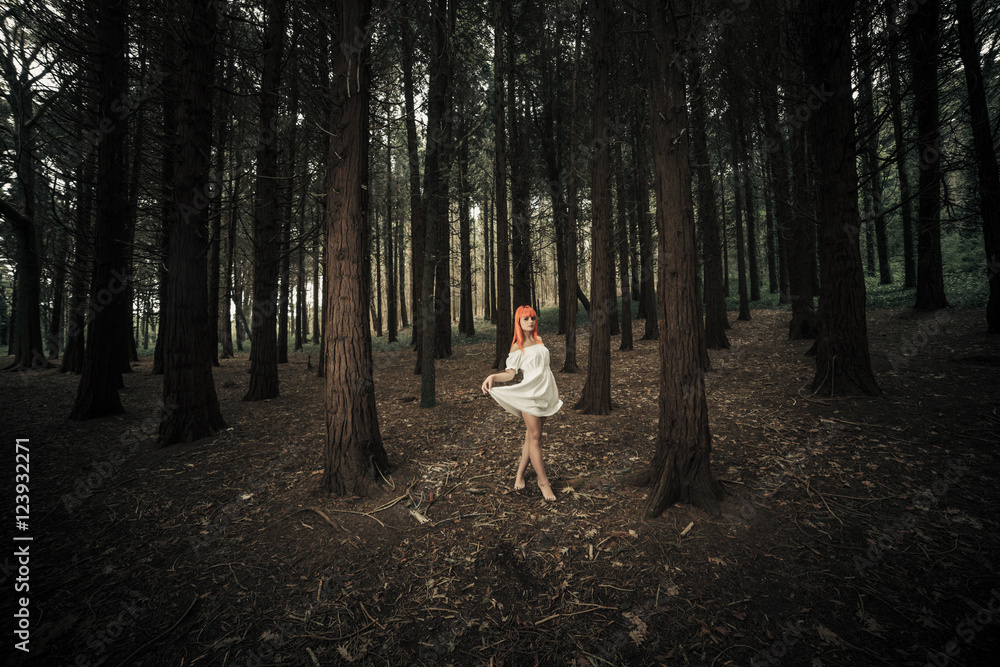 Fototapeta premium Woman in white dress in the woods