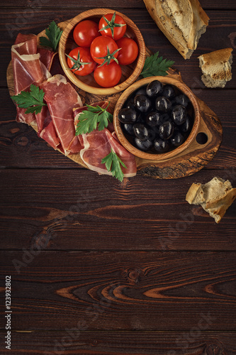 Plate with snack - prosciutto, jamon, ham.