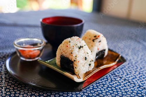 onigiri rice balls with pickled ginger and miso soup on little flower napery