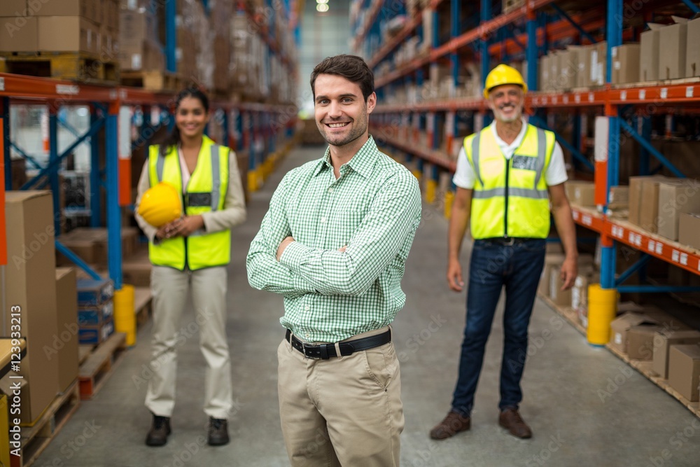 Portrait of warehouse team standing with arms crossed Portrait of warehouse team standing with arms crossed