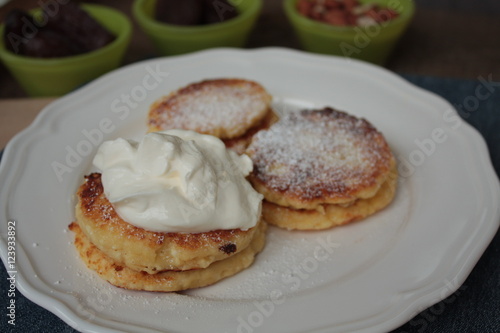 Russian sweet cheese pancakes with sour cream for Breakfast or a snack - it's delicious