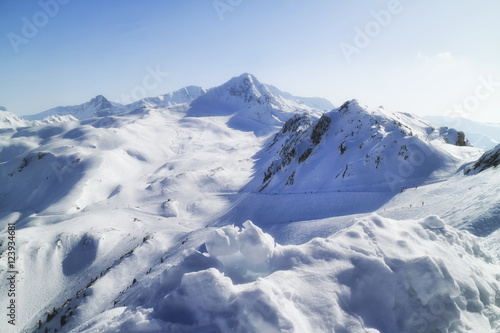 Winter snow view of French Alps mountain range with ski slopes and lifts