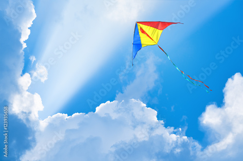 Kite flying in the sky among the clouds photo