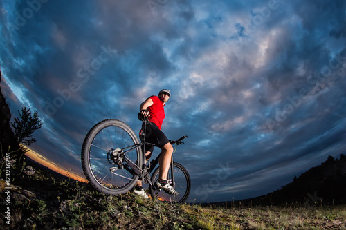 Man in helmet and glasses stay on the bicycle