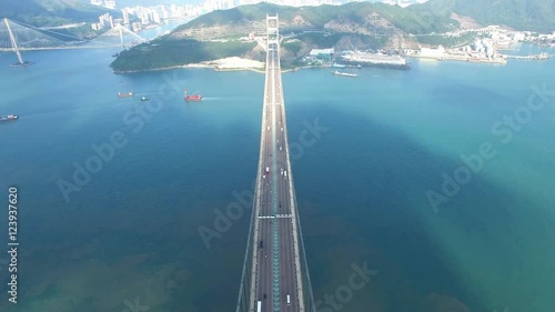 An aerial view fly over Tsing Ma Bridge under sunny day
