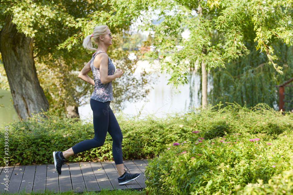 Running is my daily routine. Shot of a beautiful fit female runner training outdoors. Running is my daily routine. Shot of a beautiful fit female runner training outdoors.