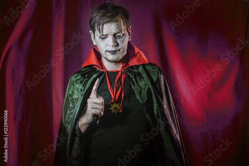 Photography vampire count Dracula waves his hand and shows a scary gesture
