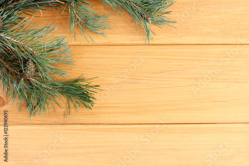 holiday background with nature elements/ flat layout with branches and cones of pine, on a wooden surface top view 