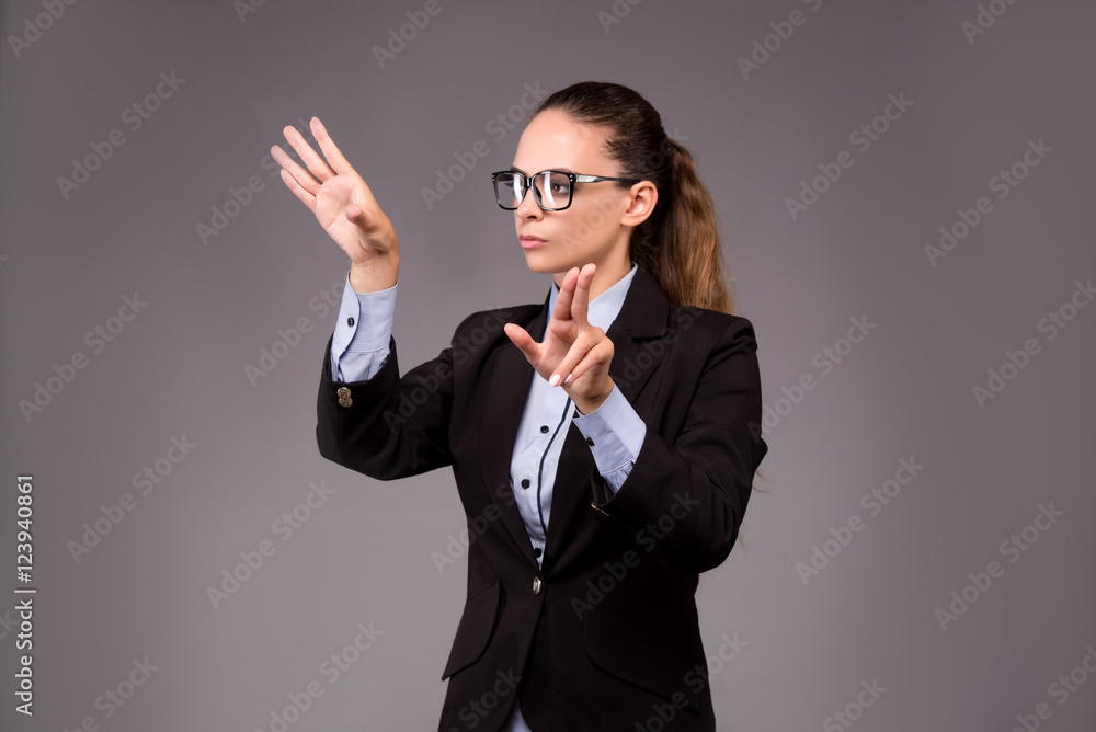 Young woman businesswoman pressing virtual buttons Young woman businesswoman pressing virtual buttons