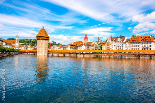 Cityscape view on the famous wooden bridge and tower on Reuss river in Lucerne old town in Switzerland
