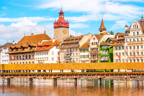 View on the riverside with city hall and old wooden bridge in Lucerne old town in Switzerland