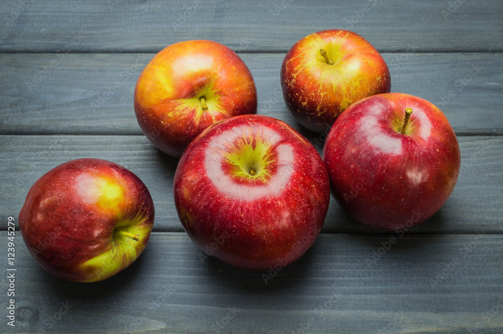 Whole green red ripe apples autumn harvest from above on dark gray blue wooden table Whole green red ripe apples autumn harvest from above on dark gray blue wooden table