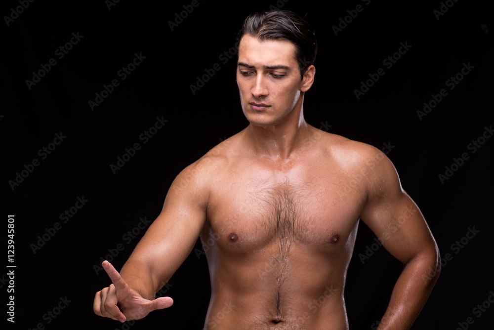 Ripped muscular man pressing virtual buttons Ripped muscular man pressing virtual buttons