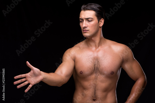 Ripped muscular man pressing virtual buttons