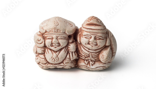 Netsuke of two fishermen with their catch. Isolated. A miniature