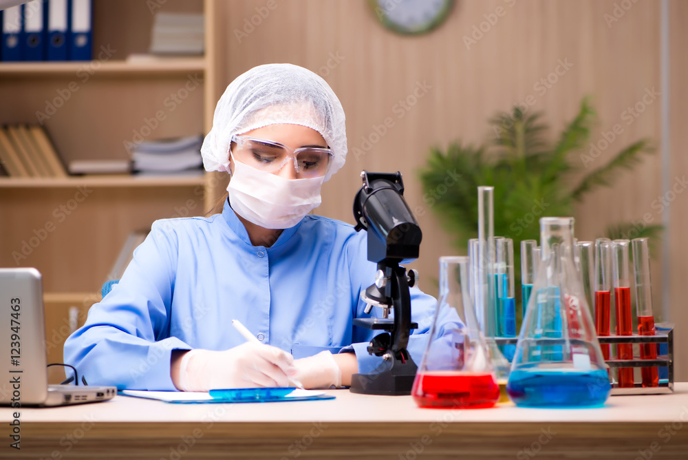 Lab chemist working with microscope and tubes Lab chemist working with microscope and tubes