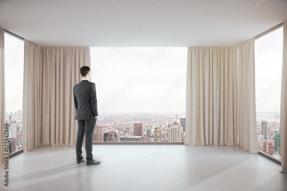 Man in room with city view Man in room with city view