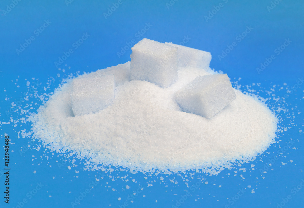 Pile of white sugar isolated on blue background Pile of white sugar isolated on blue background