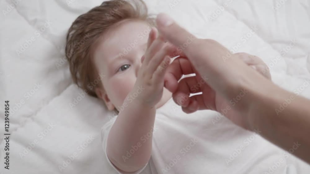 Mother's point of view of her curious baby reaching for her hand.
Mother's point of view of her curious baby reaching for her hand.