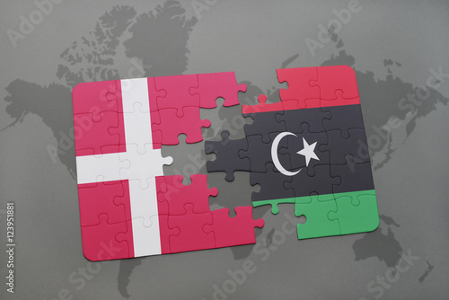 puzzle with the national flag of denmark and libya on a world map background.
