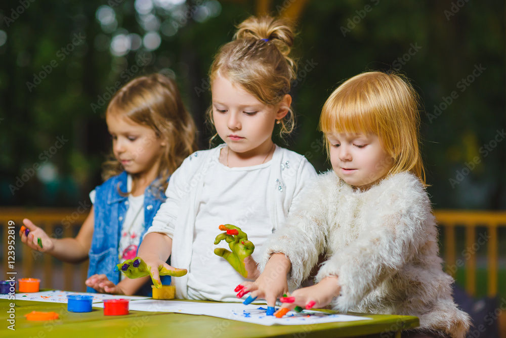 Fototapeta premium Children having fun painting with finger paint