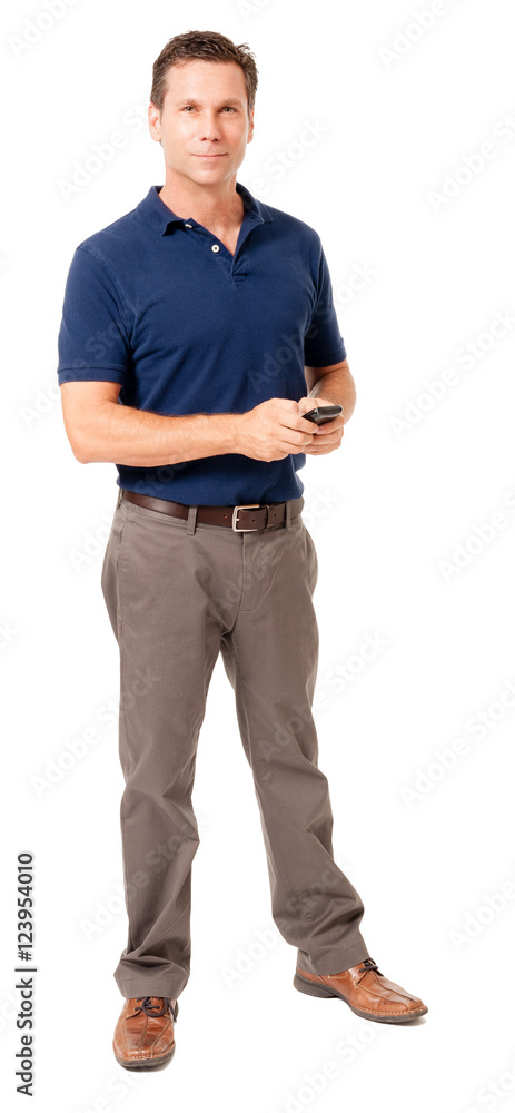 Full-length causal dress male man businessman in blue polo shirt texting with mobile cell phone isolated on white Full-length causal dress male man businessman in blue polo shirt texting with mobile cell phone isolated on white