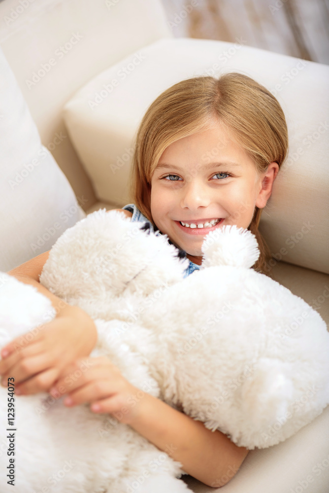 Pretty child playing with teddy bear