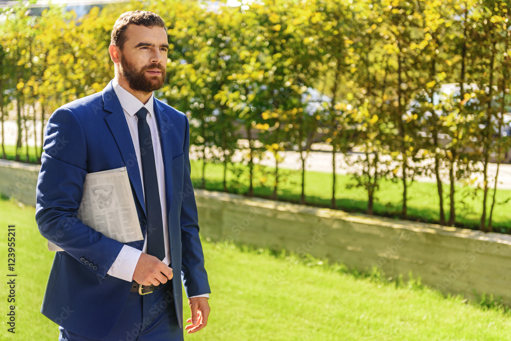 businessman walking on the grass businessman walking on the grass