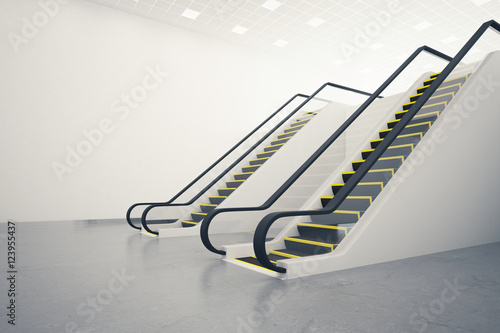 Two escalators and blank wall