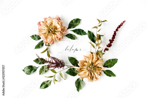 calligraphy word autumn and round frame wreath pattern, beige dried peonies flowers, branches and leaves isolated on white background. flat lay, top view, mock up photo