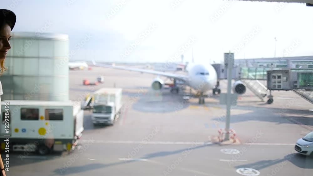 girl standing at the window in airport terminal. girl standing at the window in airport terminal.