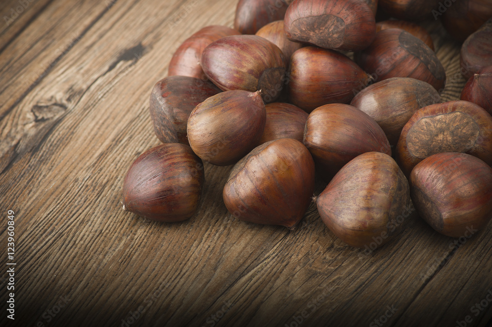 Fototapeta premium group of chestnuts on a wooden table
