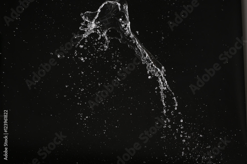 Wate splash with bubbles in space. Close up. Black background