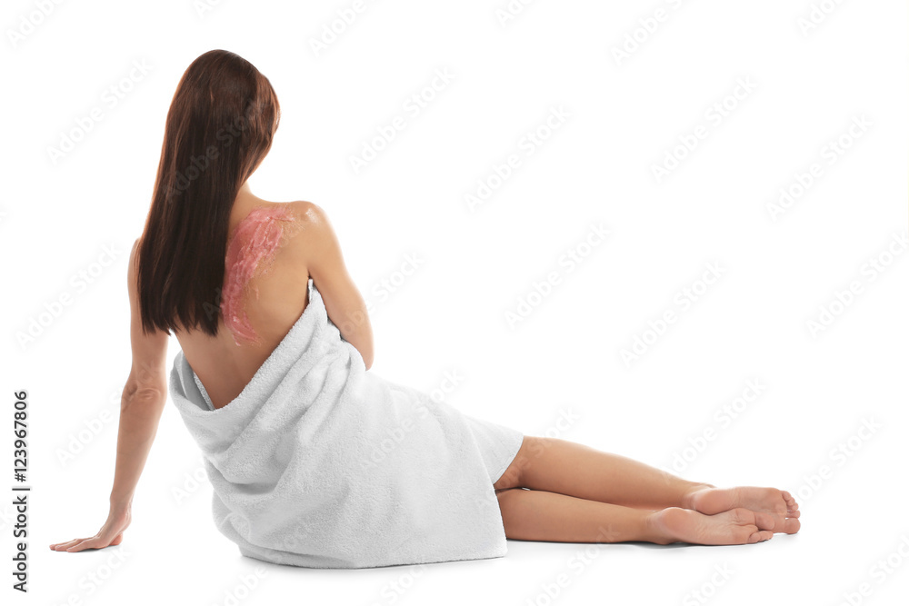 Young woman with nourishing scrub on back sitting on white background Young woman with nourishing scrub on back sitting on white background