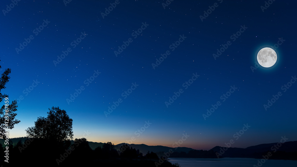 Midnight sky with full moon above river landscape Midnight sky with full moon above river landscape