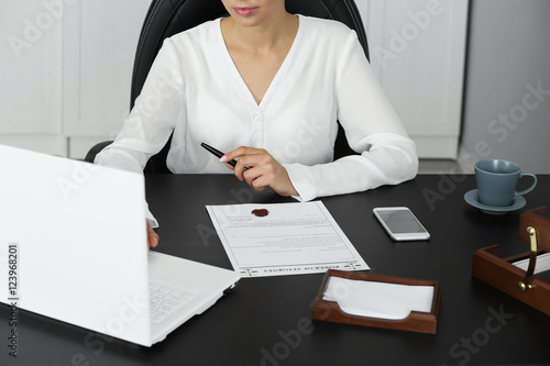 Woman working with laptop i...