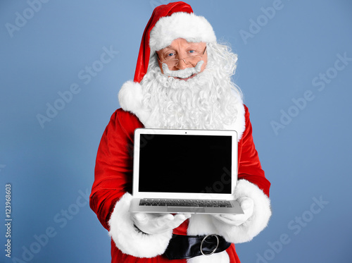 Santa Claus holding laptop ...