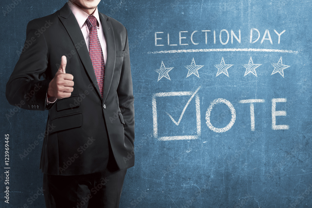 Man with business suit standing beside 'Election Day' Man with business suit standing beside 'Election Day'