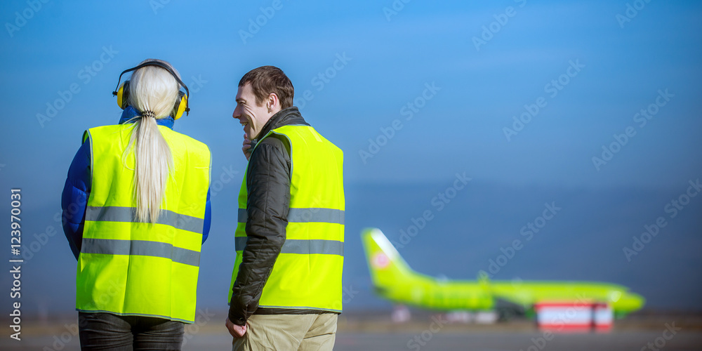 Naklejka premium airport staff looking at aircraft