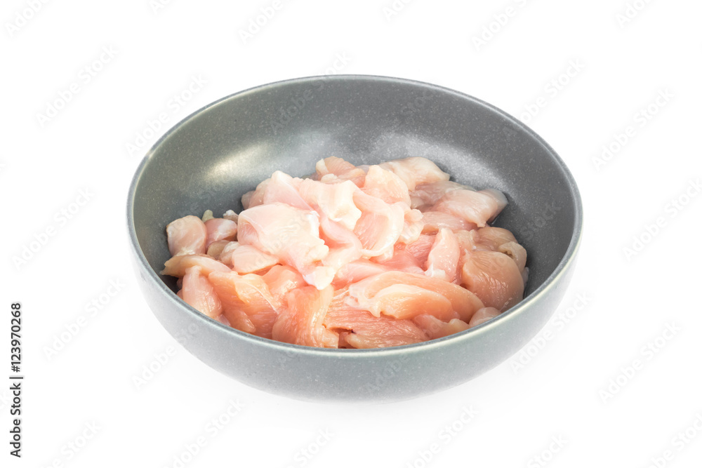 Pieces of raw chicken fillet in bowl on white background, raw ma Pieces of raw chicken fillet in bowl on white background, raw ma