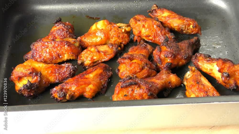 pan with cooked chicken wings resting on the table pan with cooked chicken wings resting on the table