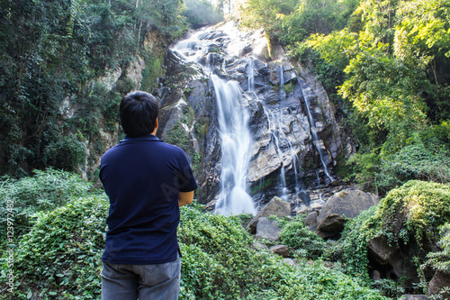 Thai man with Mae Tia Waterfall, Obluang National Park, Chiangma photo