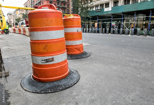 Photography A traffic barricade of orange barrels indicates a site of road construction work in Manhattan