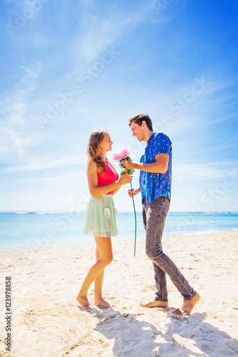 man making a proposal to a woman on a beach