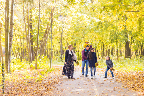 Happy young family spending time together outside in autumn nature.