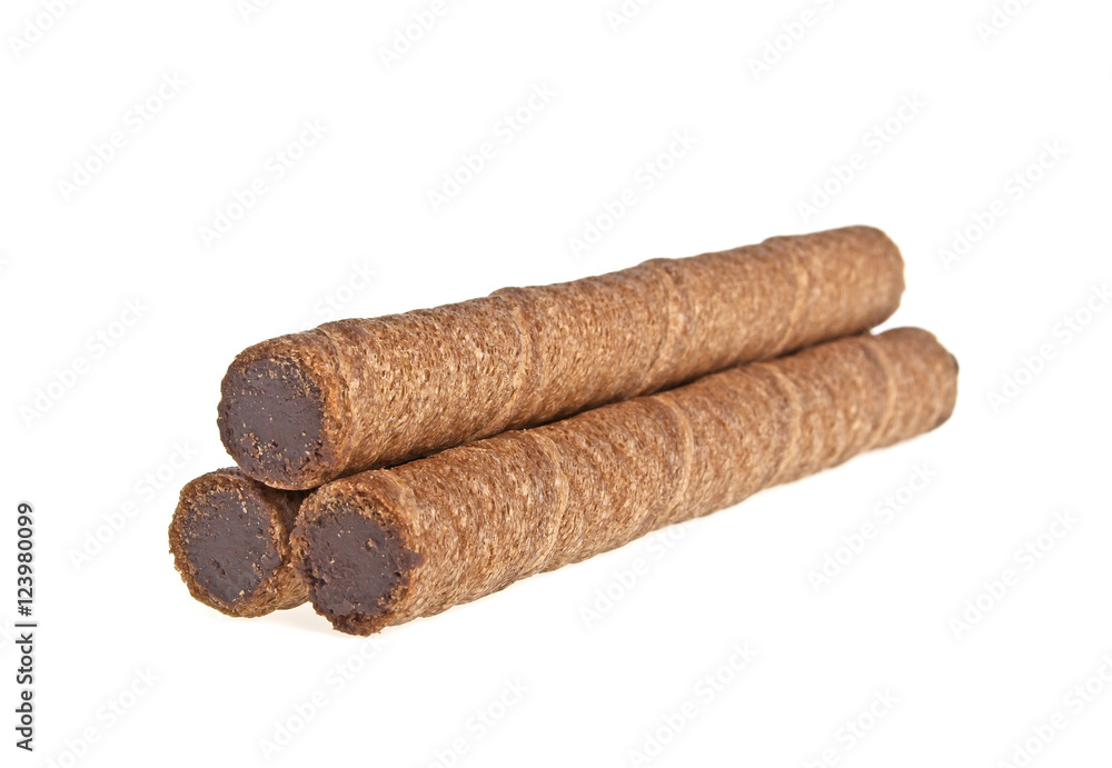 Wafer roll with chocolate and cocoa coating on a white backgroun Wafer roll with chocolate and cocoa coating on a white backgroun