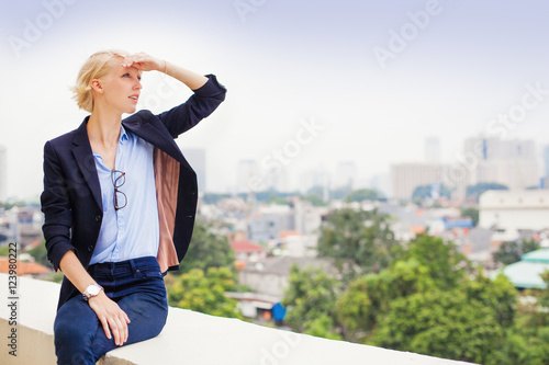 pensive beautiful european woman looking at the city