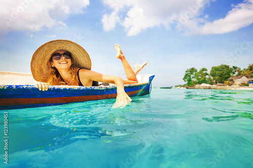 woman paddling in a boat in a paradise island © Mila Supinskaya 