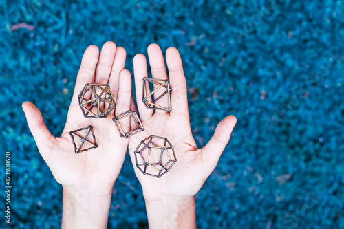 Hands holding sacred geometry