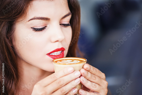 woman with sensitive teeth tasting coffee